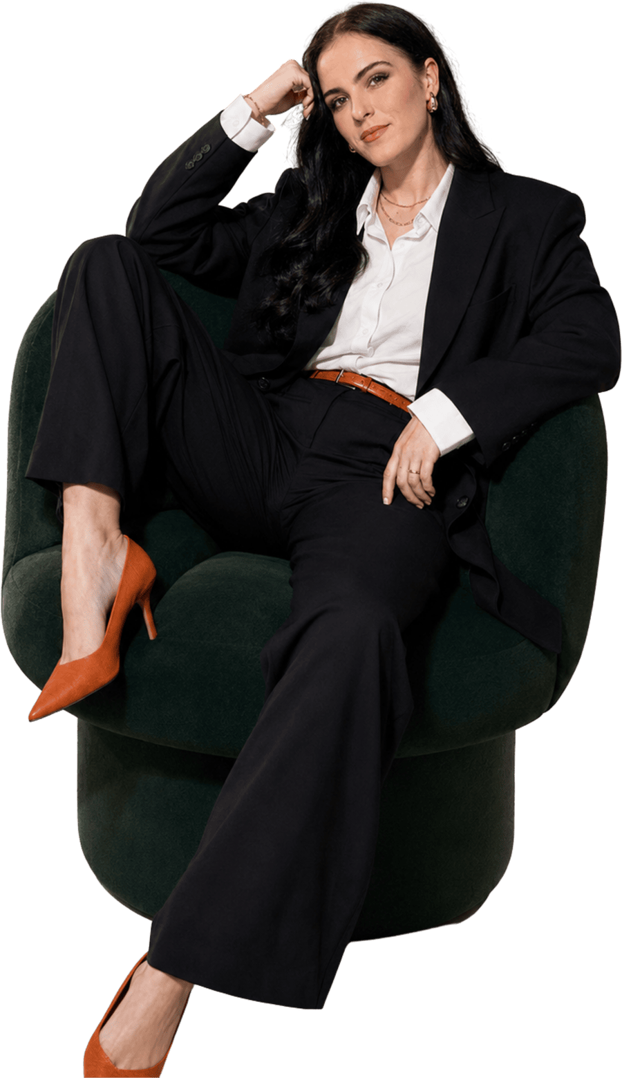 Brande-Lee, founder of The Brand.e House, seated in a green armchair